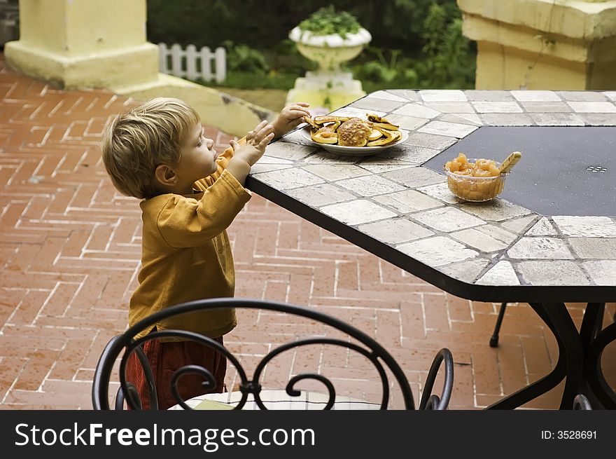 Beautiful little girl is eating pancakes. Beautiful little girl is eating pancakes