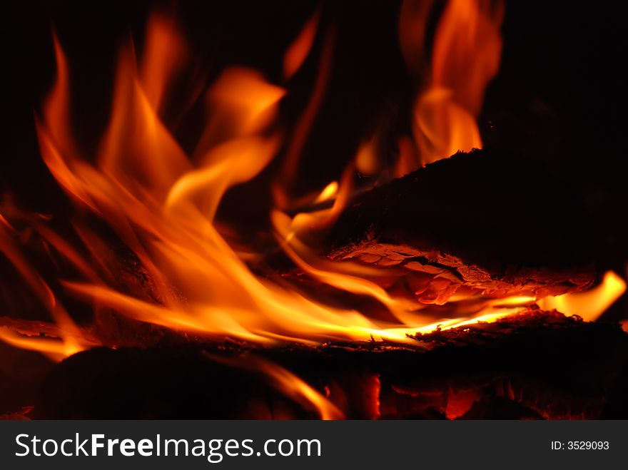 Flames in the fireplace in closeup. Flames in the fireplace in closeup