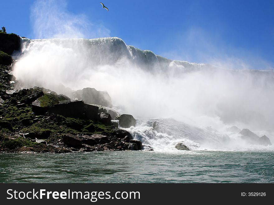 A dramatic river view of the rocky base of the American Falls at Niagara. A dramatic river view of the rocky base of the American Falls at Niagara.