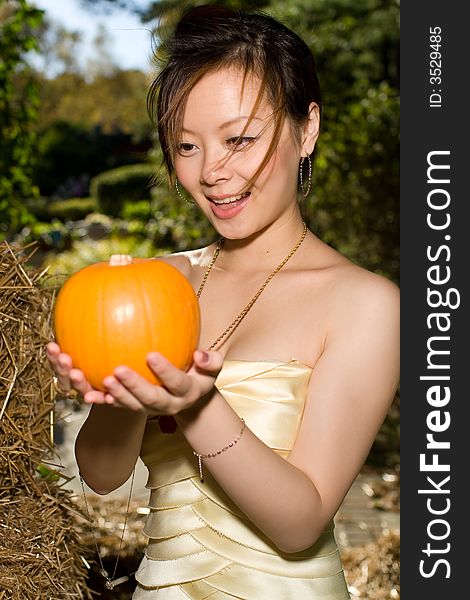 A girl watching a pumpkin surprisingly. A girl watching a pumpkin surprisingly