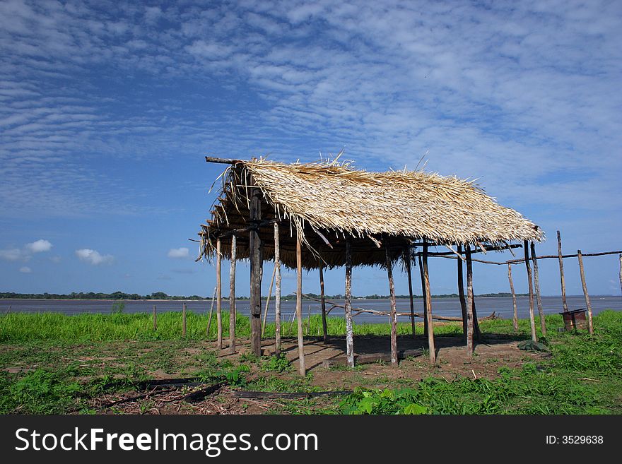 Hut of straw on the banks of the Amazon River, Brazil. Hut of straw on the banks of the Amazon River, Brazil.