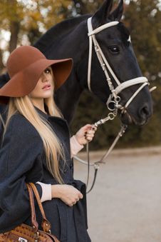 Beautiful Girl With Black Horse Royalty Free Stock Photos