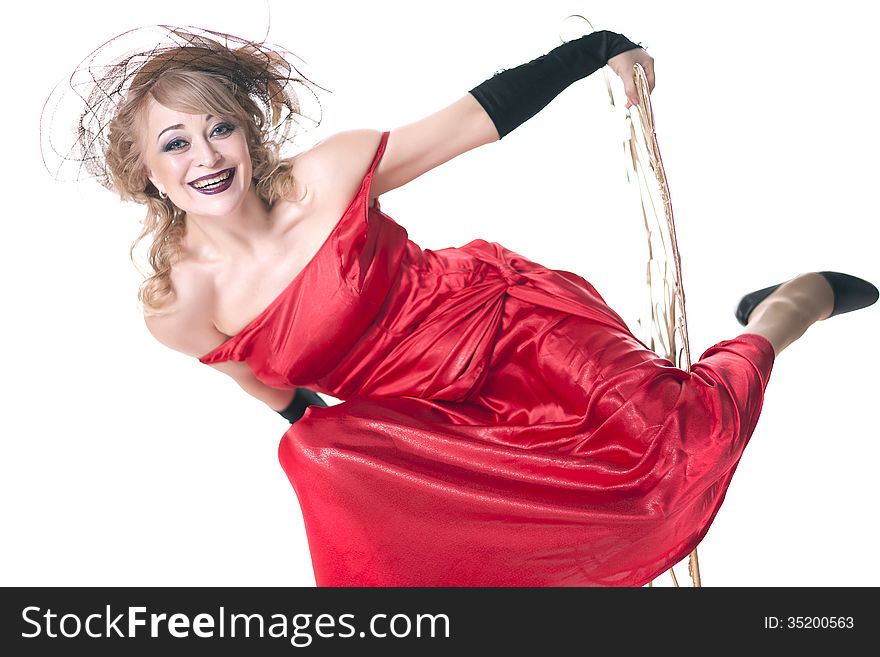 Woman in a red dress posing on a chair on a white background
