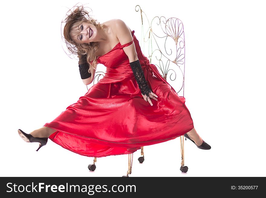 Woman In A Red Dress Posing On A Chair