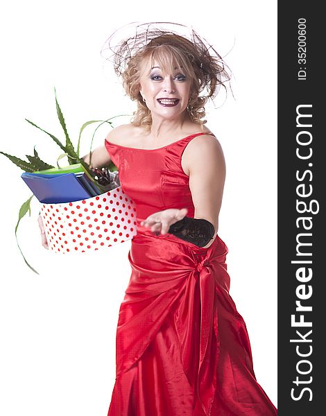 Fired actress in a red dress with a box of things express her emotions on a white background. Fired actress in a red dress with a box of things express her emotions on a white background