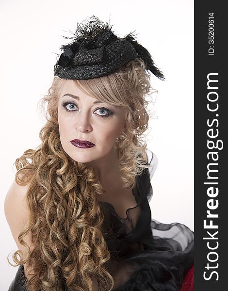 Portrait of woman with curly hair in pretty hat on white background