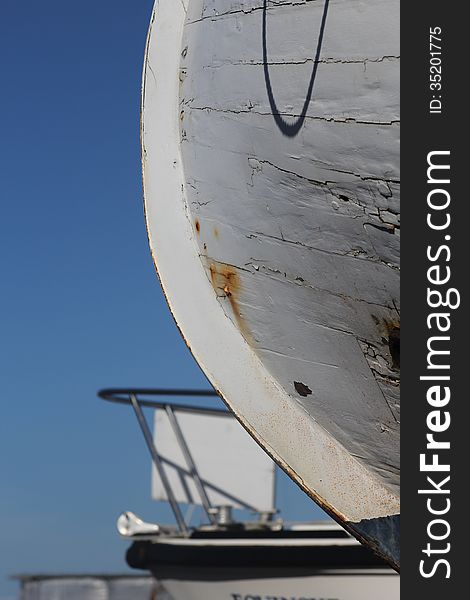 Detail of boat hull in dry dock marina.