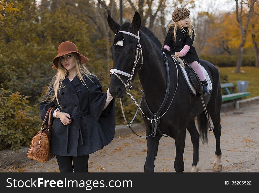 Happy family with black horse