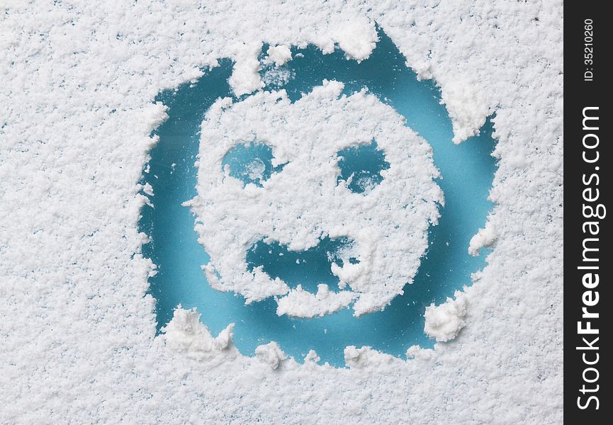 Drawing of smile face on snow winter background. Drawing of smile face on snow winter background