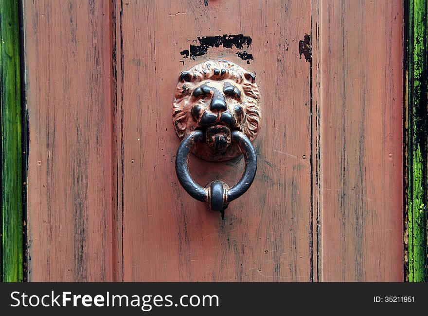 Doorknob lion head on an old door