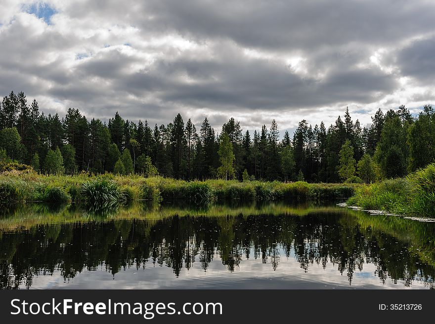 Beautiful river coast in the wild Karelian (Karjala) woods. Beautiful river coast in the wild Karelian (Karjala) woods