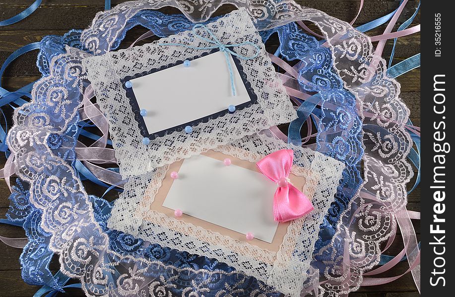 Pink and blue greeting cards on wooden background