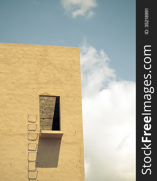 Building wall with metallic stairs and cloudy sky. Building wall with metallic stairs and cloudy sky