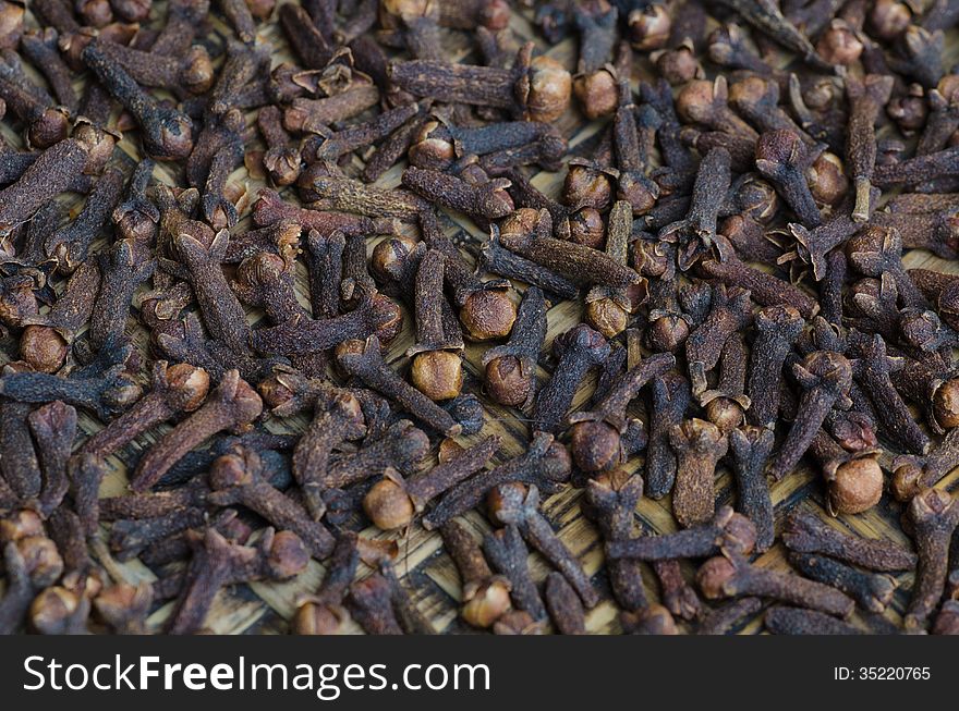 A lot of dry cloves closeup as a background. A lot of dry cloves closeup as a background.