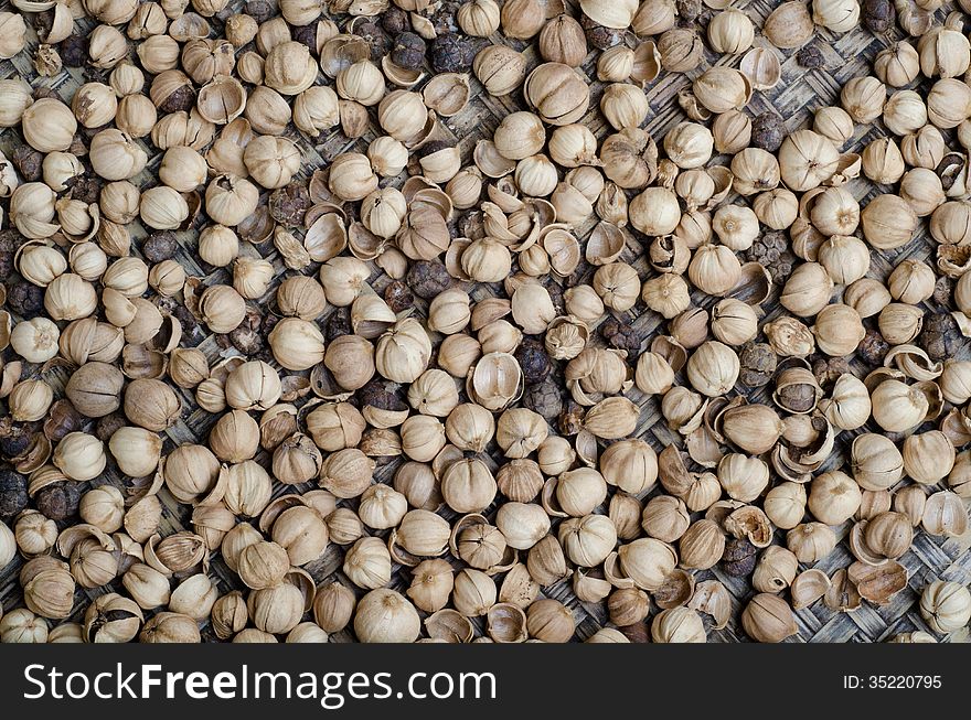 Dride Siam Cardamom(Amomum krervanh Pierre) on bamboo background. Dride Siam Cardamom(Amomum krervanh Pierre) on bamboo background