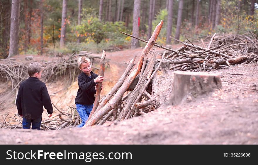 Two boys building a shanty in a forest. Two boys building a shanty in a forest
