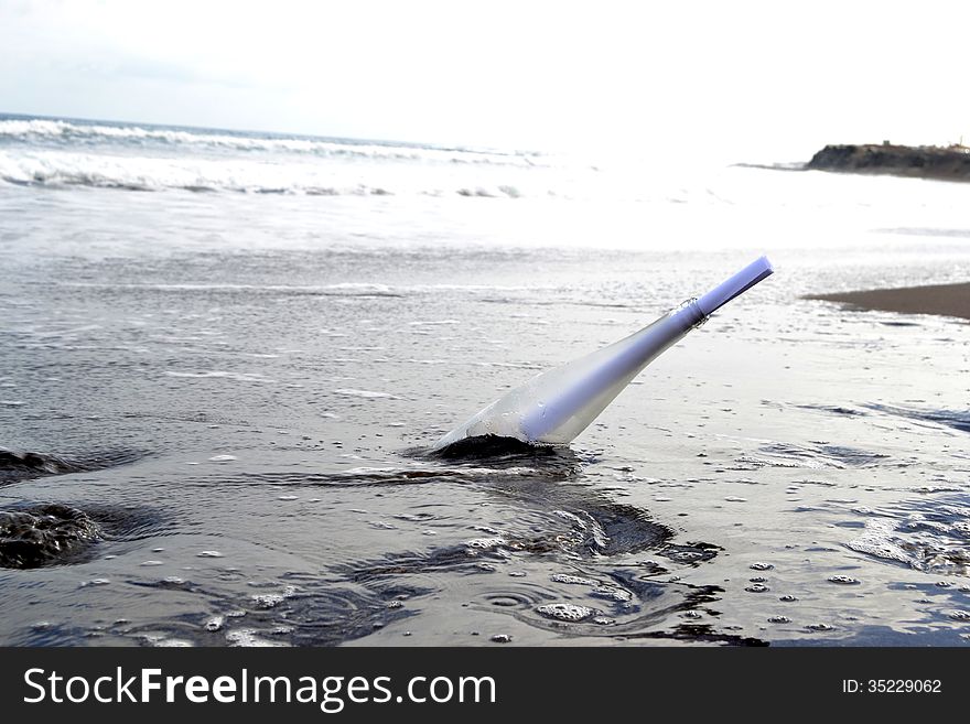 Bottle in the sand of beach. Bottle in the sand of beach