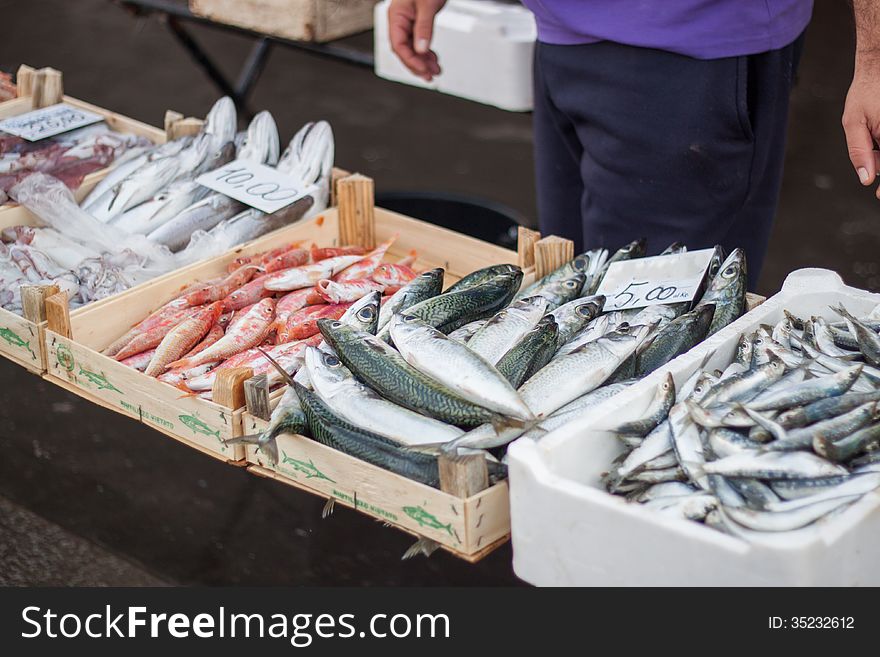 A man selling fresh fish in the fish market