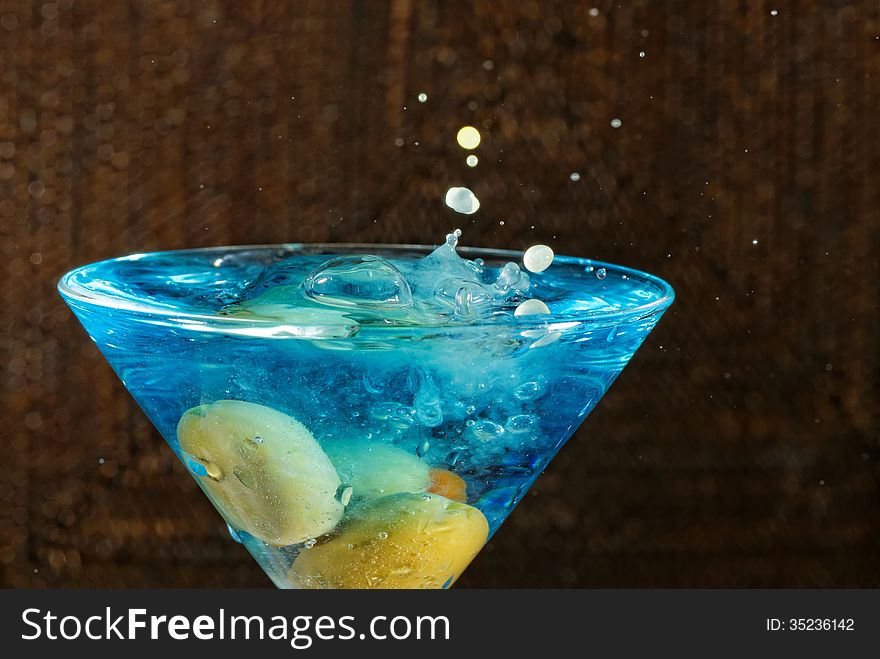 Blue Martini drink with green olives