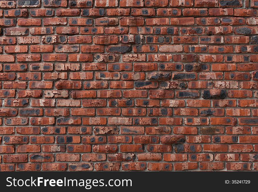 Brown brick wall with spots