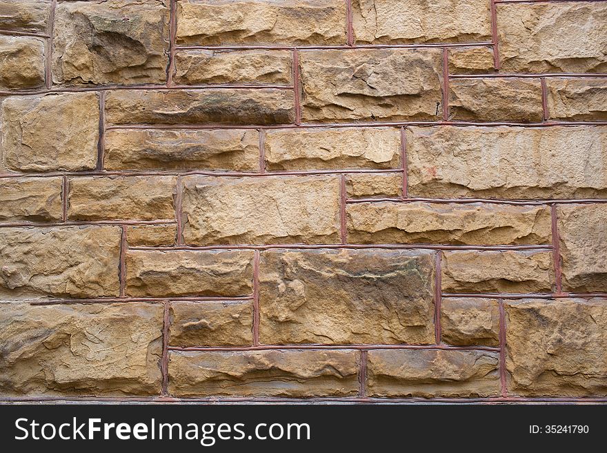 Brown brick wall with large blocks