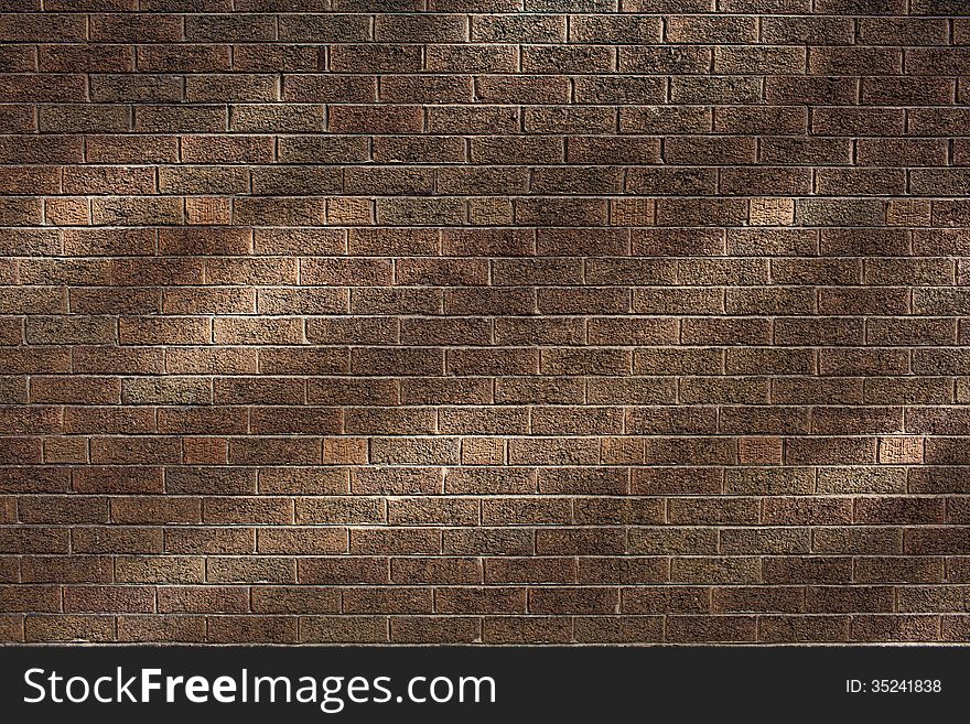 Brown brick wall with light spots