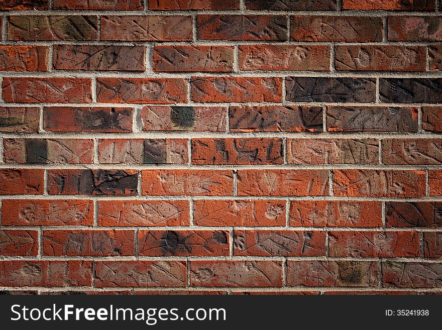 Brown brick wall with marks