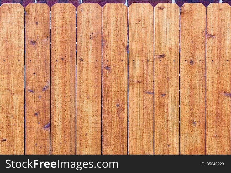 Orange wooden fence with marks