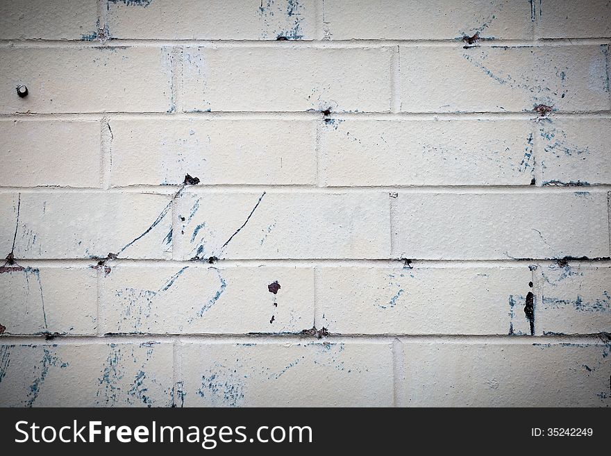 White brick wall with blue spots