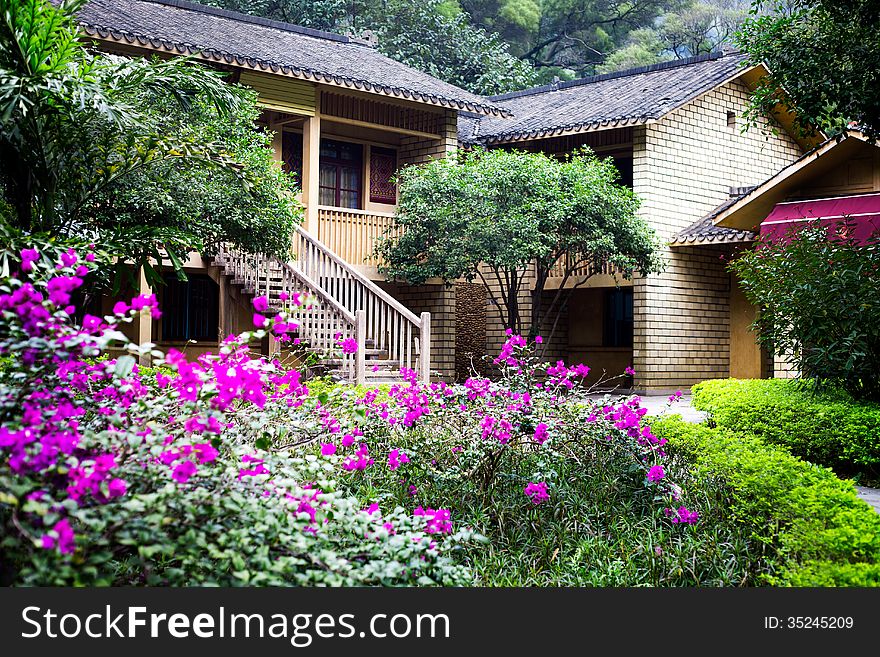 Chinese countryside villa with blooming flower in botanical garden