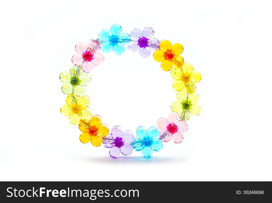 Toy plastic bracelet with flower colorful bead isolated on white. Toy plastic bracelet with flower colorful bead isolated on white