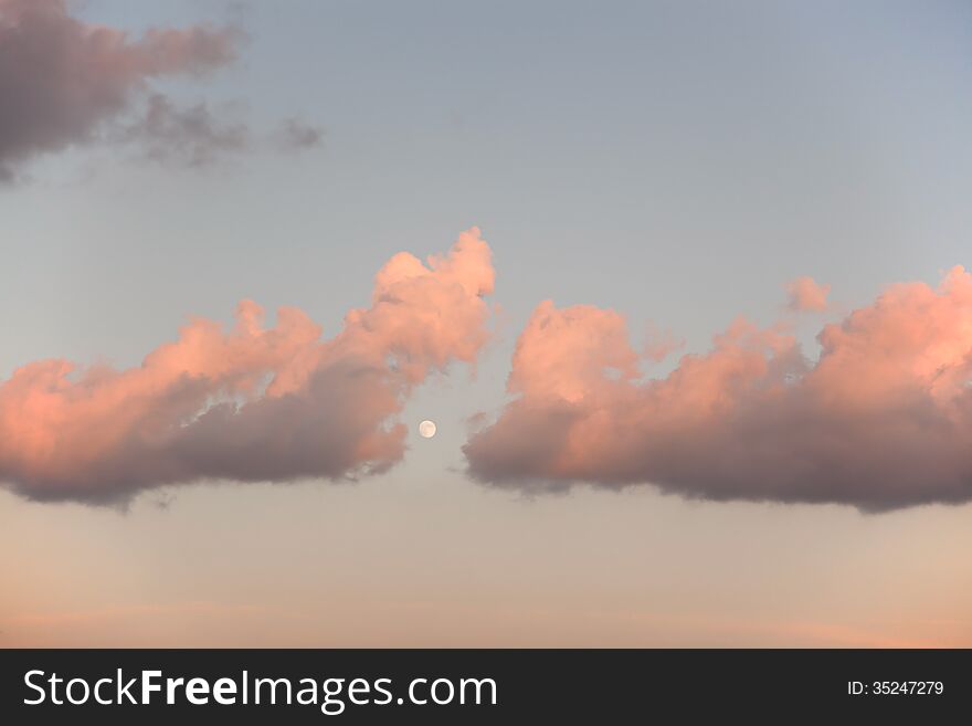 Clouds and Moon at the sunset.