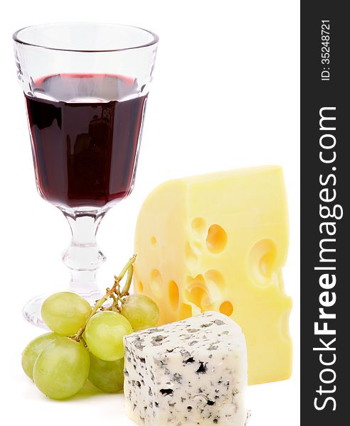 Arrangement of Red Wine, Maasdam Cheese, Dorblu Cheese and Green Grapes isolated on white background. Arrangement of Red Wine, Maasdam Cheese, Dorblu Cheese and Green Grapes isolated on white background