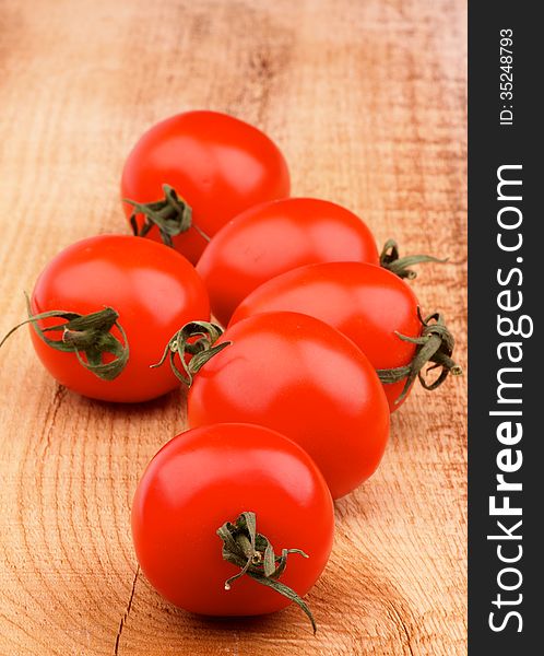 Fresh Ripe Cherry Tomatoes In a Row on Rustic Wooden background