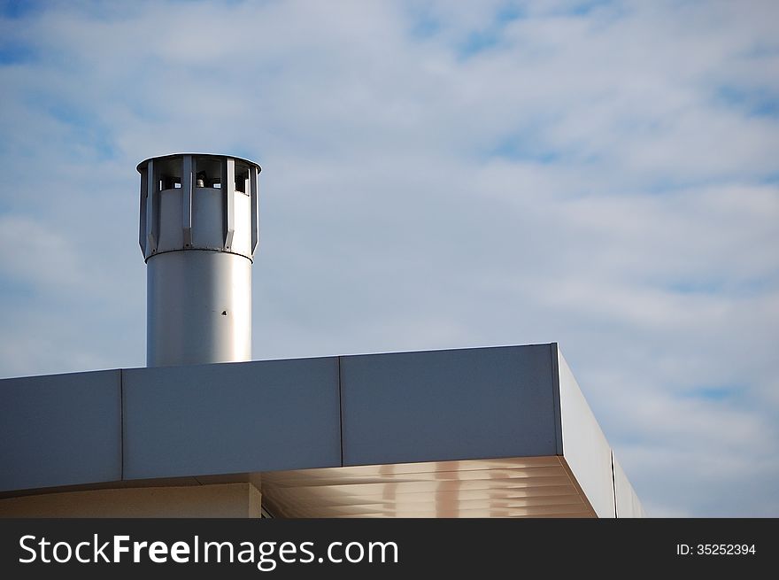 A modern chimney on top of a recent building