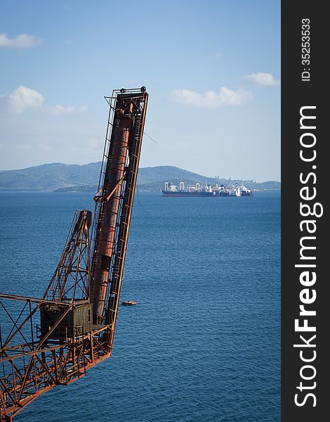 View of an old iron construction and boats at the background. View of an old iron construction and boats at the background.