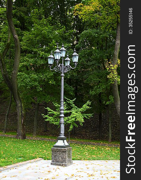 Metal lamp with five lights on the avenue of city park. Metal lamp with five lights on the avenue of city park