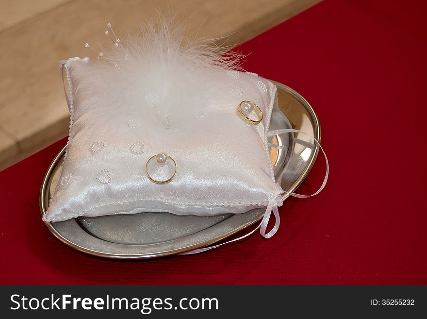 Wedding rings on a plate in Church.