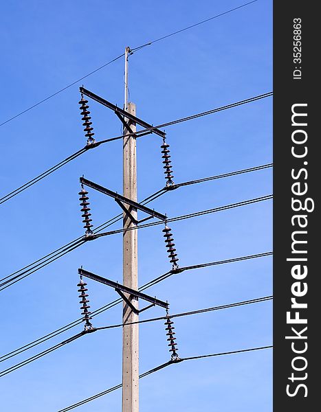 A single electricity post with blue sky