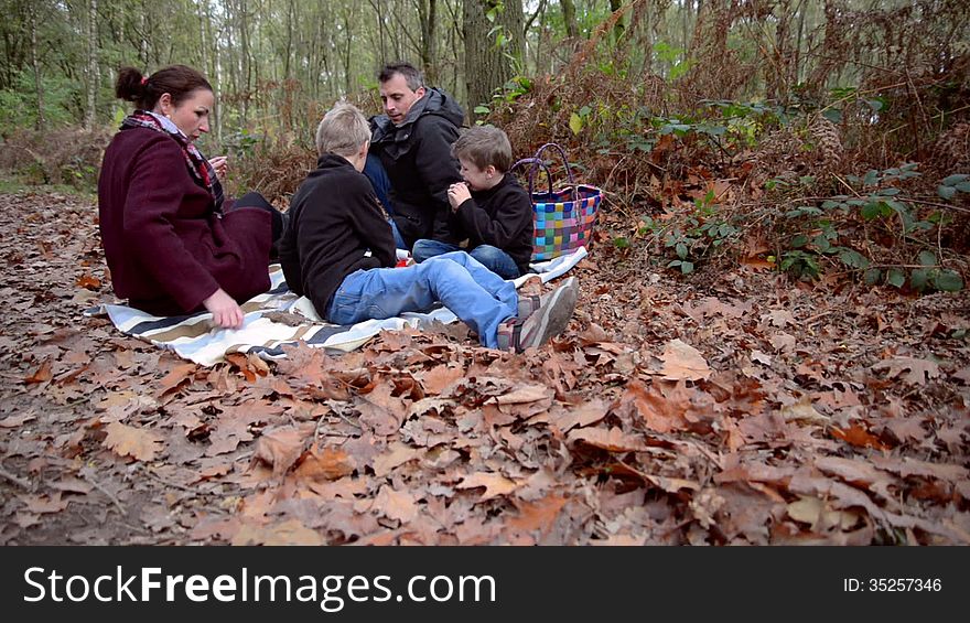 Family having a picnic in a forest. Family having a picnic in a forest