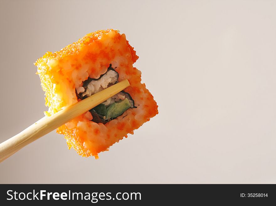 Jaoaneese sushi roll in chopstick. Jaoaneese sushi roll in chopstick.