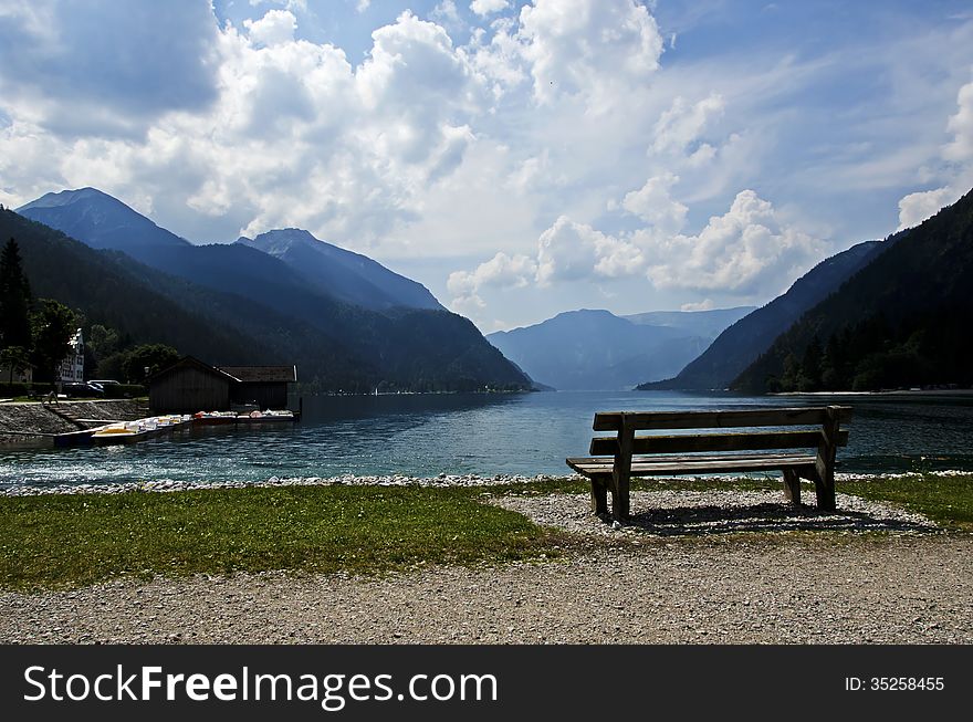 Bench on the shore of a lake in the Alps, austria