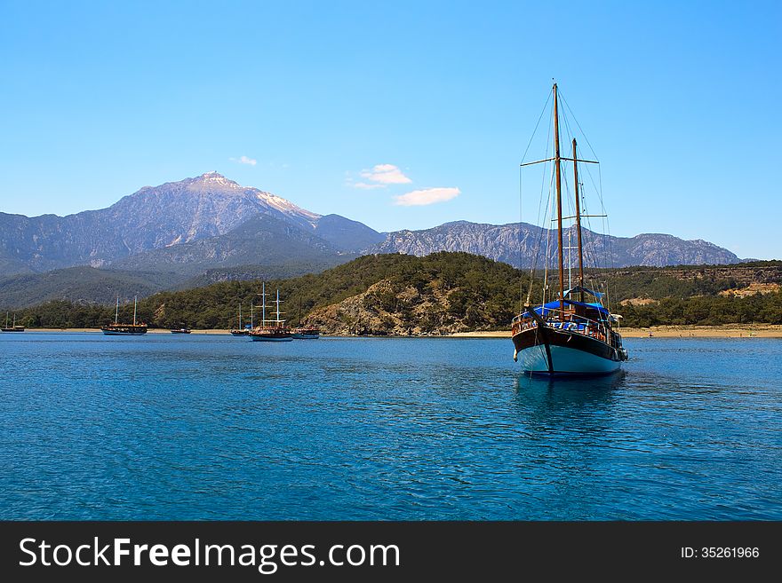 Sailing yacht sail through the sea on the background of mountains. Turkey , Kemer . 2013