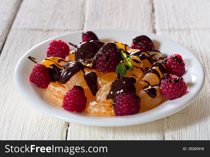 Tangerines and raspberry chocolate decorated.