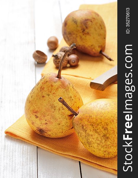 Ripe pears on a white wooden plank table