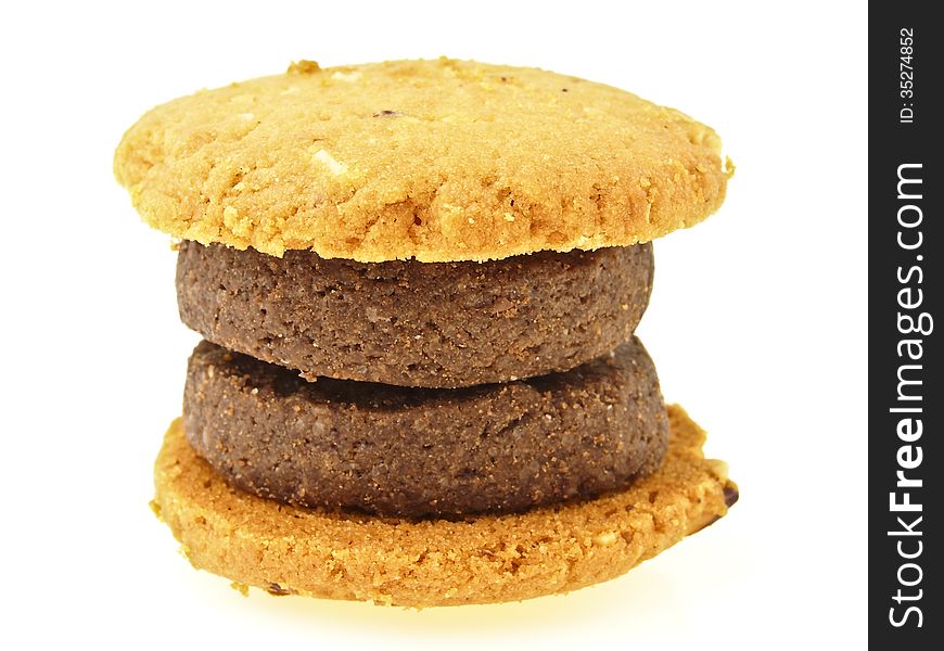 Compound of brown and yellow cookies in double hamburger shape on white background. Compound of brown and yellow cookies in double hamburger shape on white background