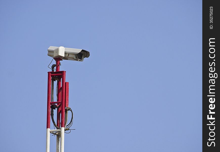 Security CCTV camera on top of pole in blue sky. Security CCTV camera on top of pole in blue sky