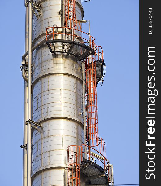 Detail of distillation tower in sunny day and blue sky. Detail of distillation tower in sunny day and blue sky