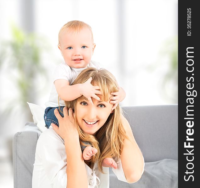 Happy Family. Baby Sits Astride The Shoulders Of The Mother