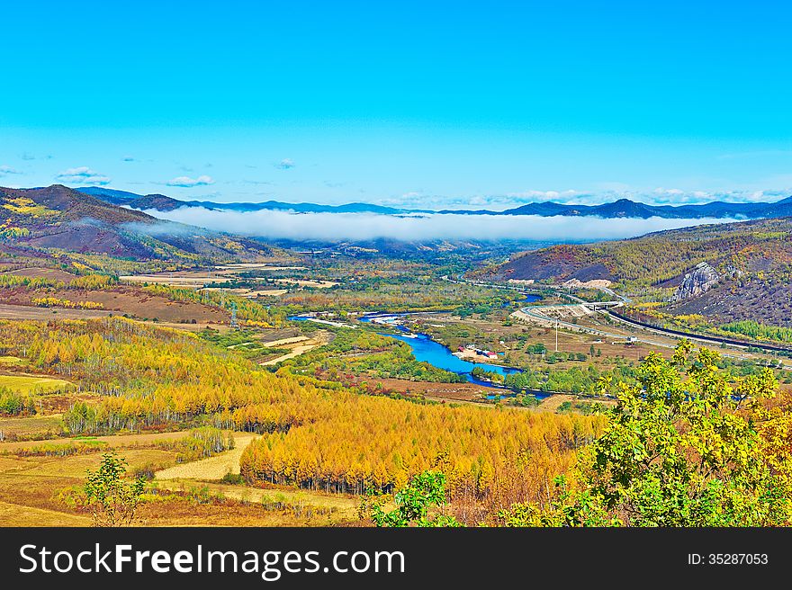 The autumn forest and blue river mist